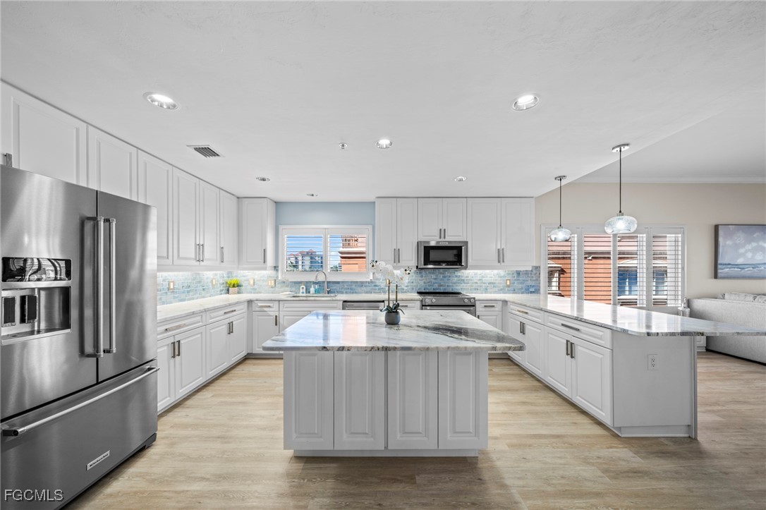 14813 Laguna Drive, Unit 301 Fort Myers, FL 33908 - Photo 3 of 50 a large kitchen with cabinets