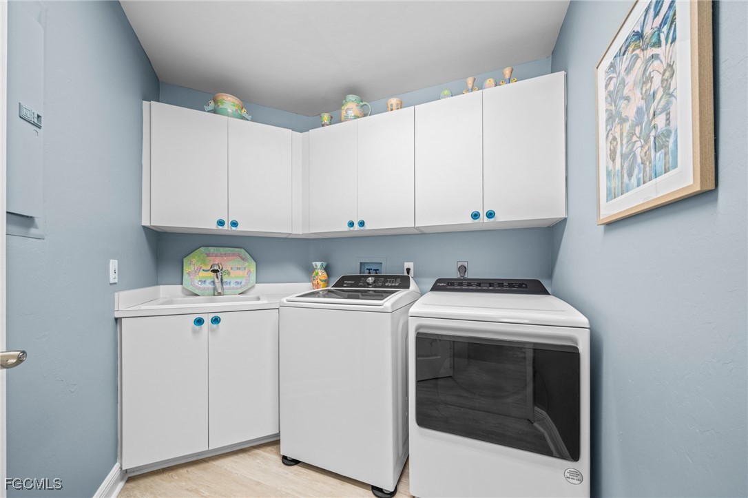 14813 Laguna Drive, Unit 301 Fort Myers, FL 33908 - Photo 31 of 50 a kitchen with cabinets appliances and a sink