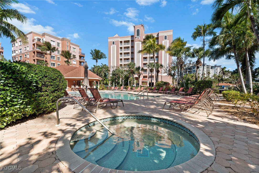 14813 Laguna Drive, Unit 301 Fort Myers, FL 33908 - Photo 46 of 50 a view of a swimming pool with outdoor seating