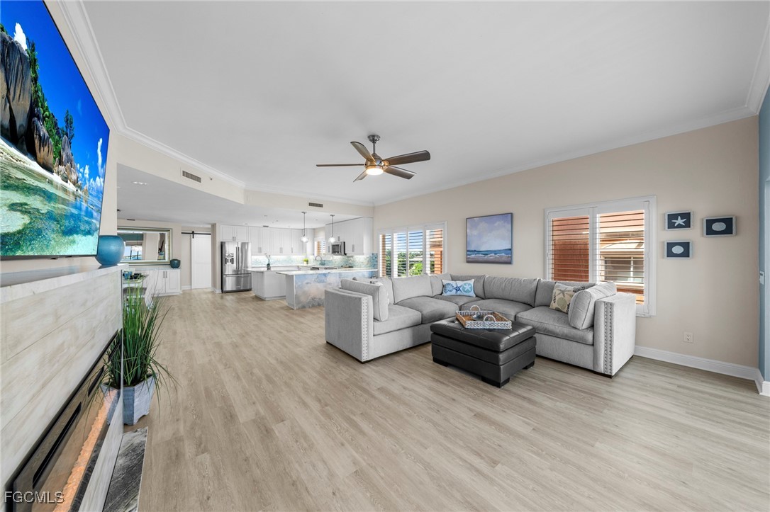 14813 Laguna Drive, Unit 301 Fort Myers, FL 33908 - Photo 8 of 50 a living room with furniture and a large window