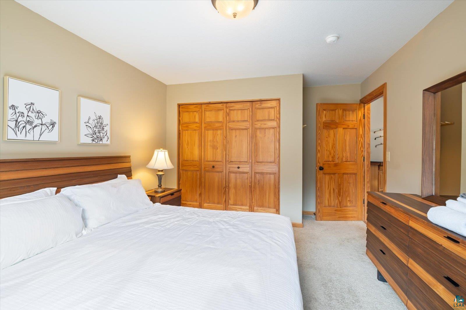 6266 Giants Ridge Road Biwabik, MN 55705 - Photo 23 of 37 Bedroom featuring light-toned walls and plush carpeting