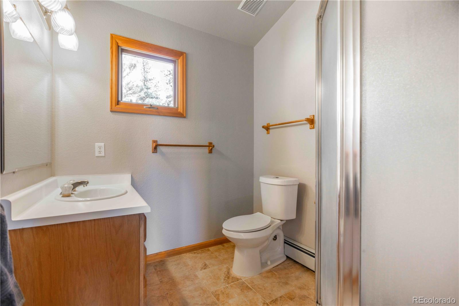 318 Rd D Pine, CO 80470 - Photo 25 of 50 a bathroom with a toilet sink and mirror