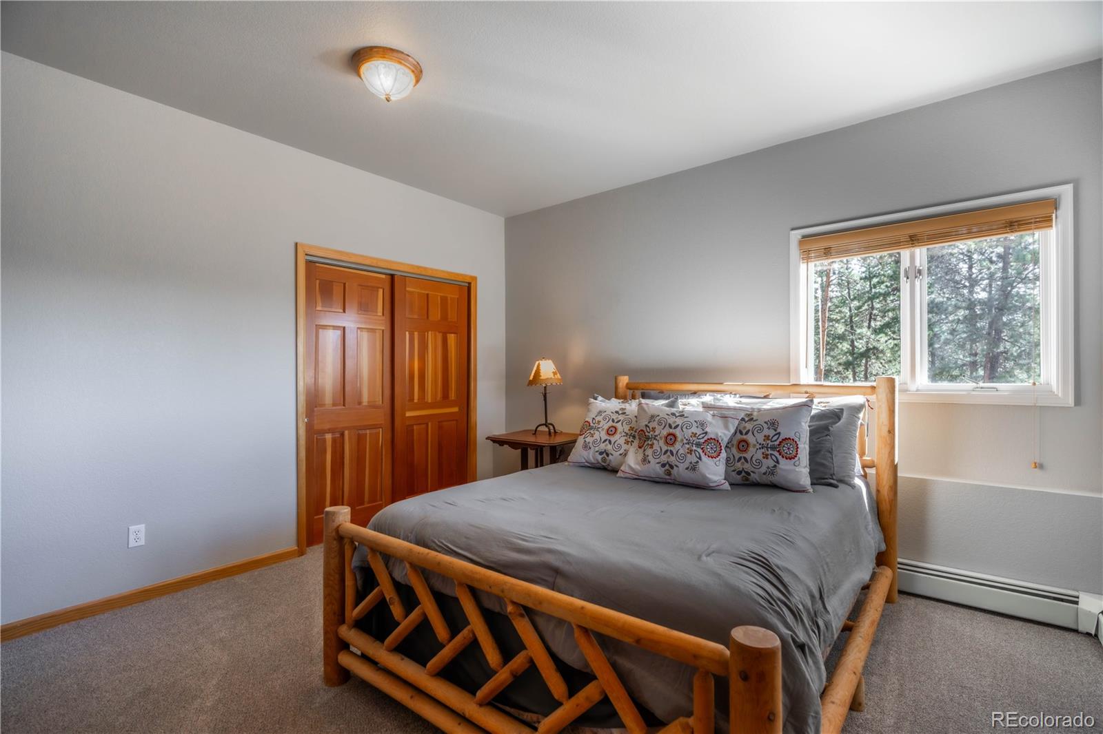 318 Rd D Pine, CO 80470 - Photo 32 of 50 a bedroom with a bed and window