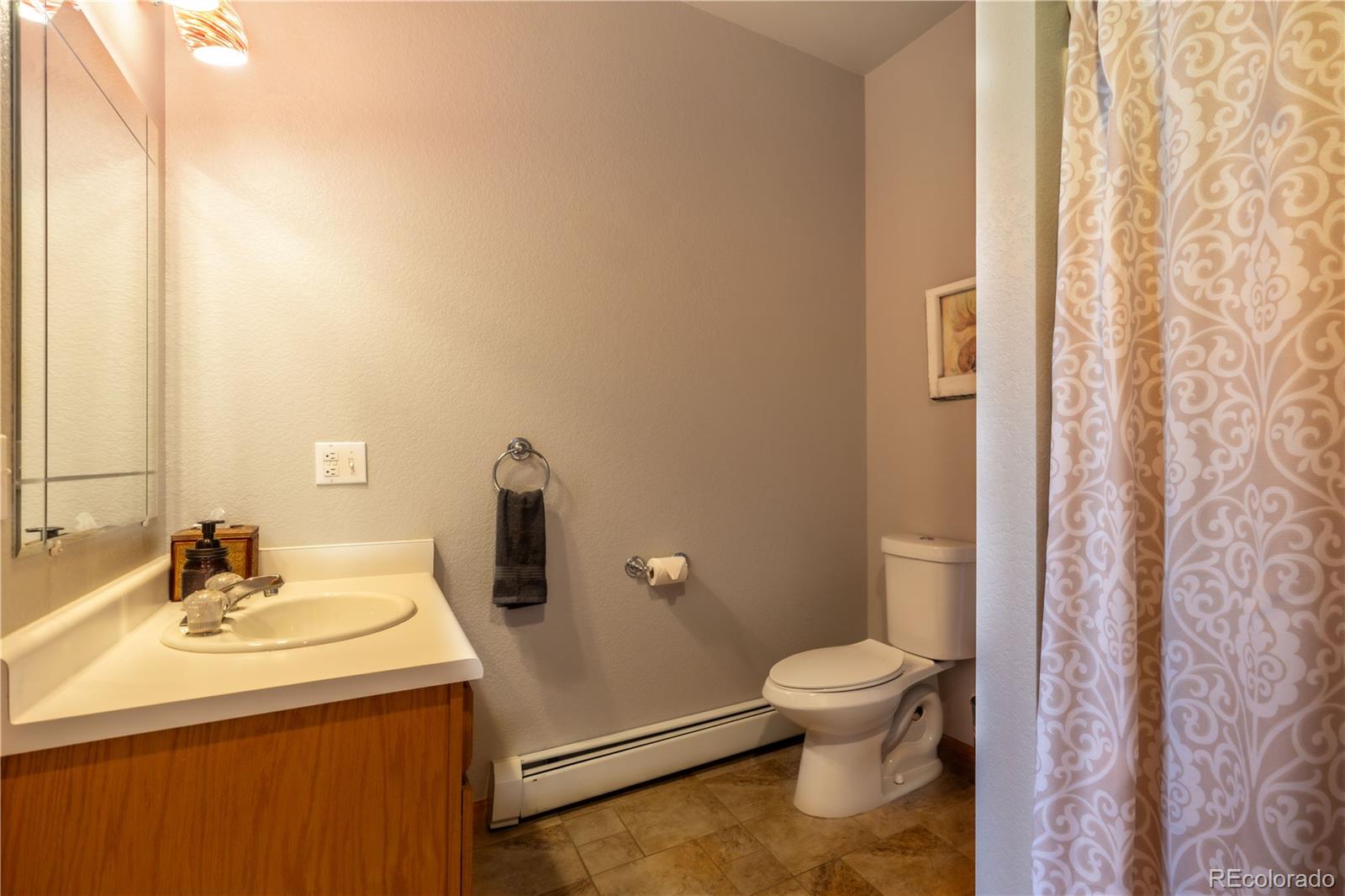 318 Rd D Pine, CO 80470 - Photo 33 of 50 a bathroom with a sink a toilet and shower curtain