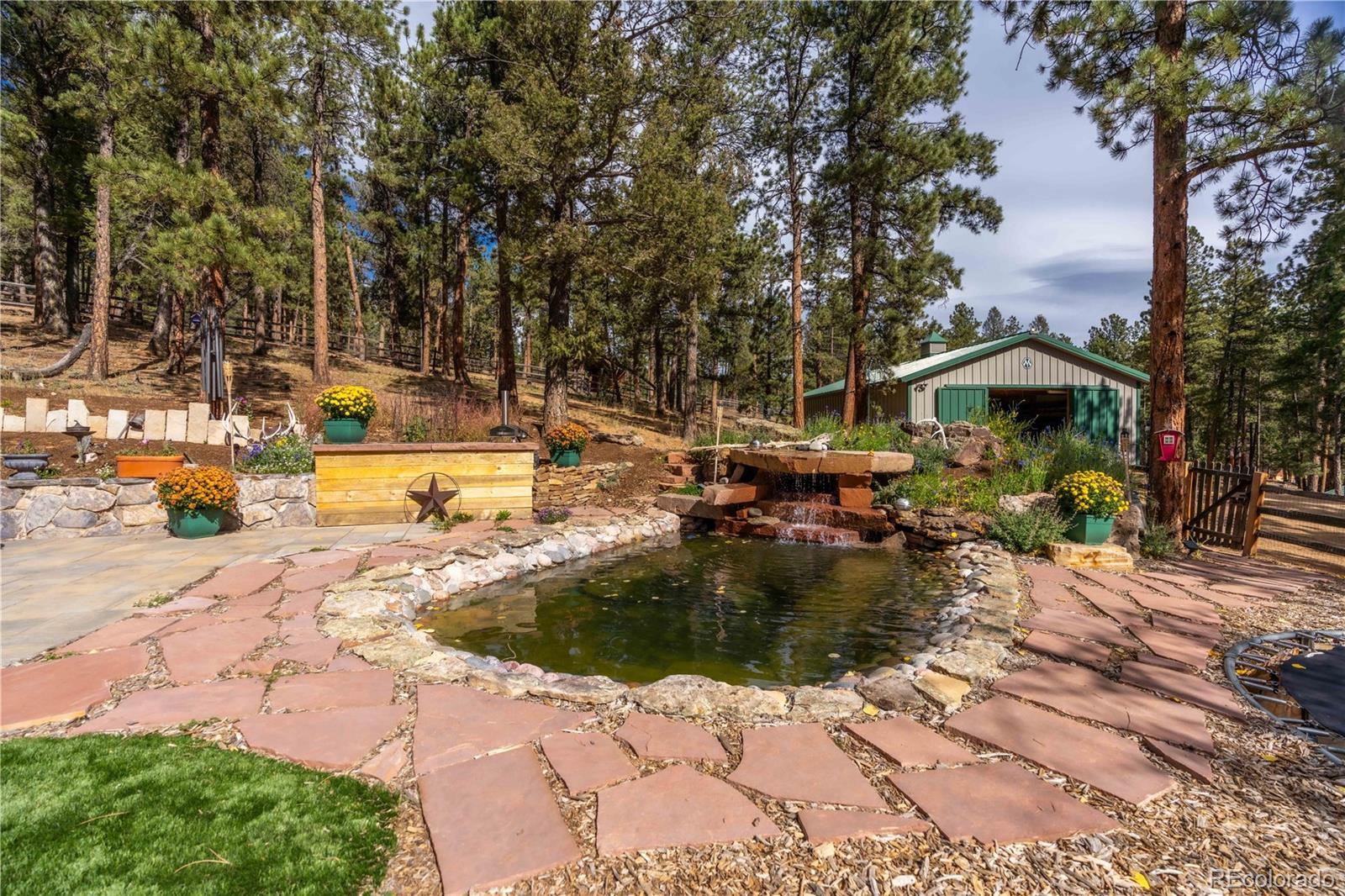 318 Rd D Pine, CO 80470 - Photo 38 of 50 a view of a swimming pool with a patio