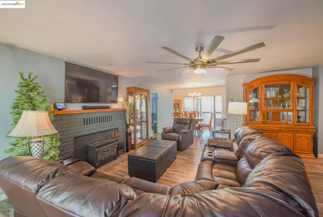a living room with furniture a fireplace and a large window