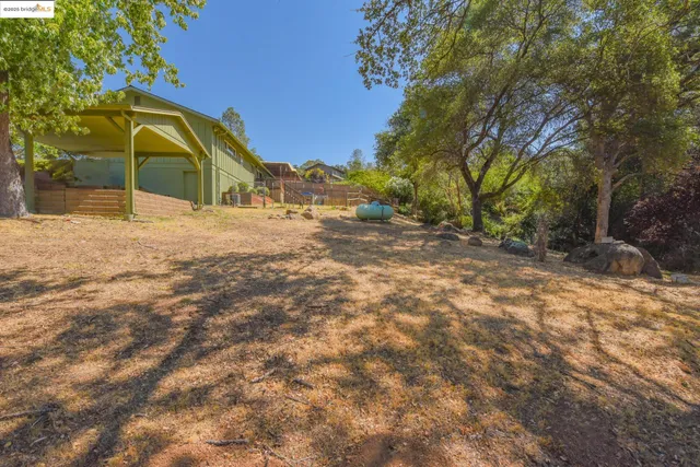 a view of yard with swimming pool and trees