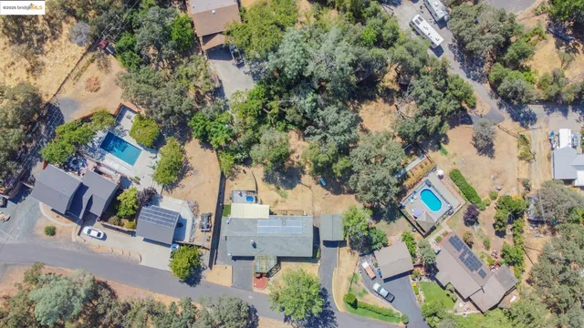 an aerial view of a house with a yard and garden