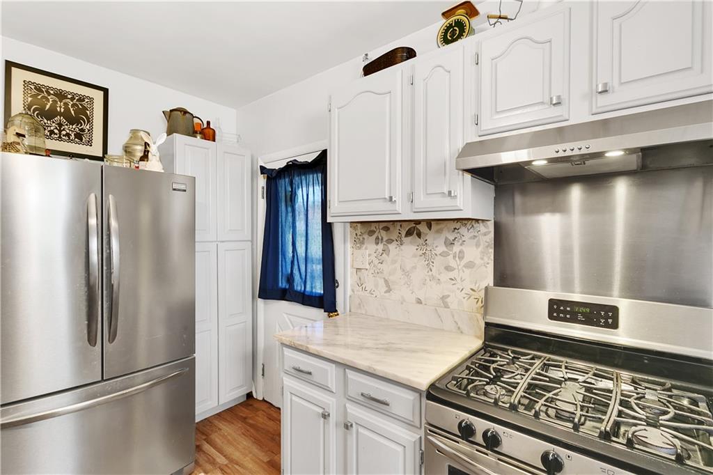 23-25 Locust Street Uniontown, PA 15401 - Photo 11 of 23 a kitchen with stainless steel appliances granite countertop a refrigerator and a stove