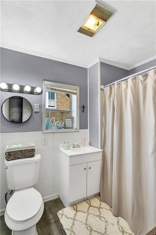 23-25 Locust Street Uniontown, PA 15401 - Photo 21 of 23 a bathroom with a toilet a sink and a mirror