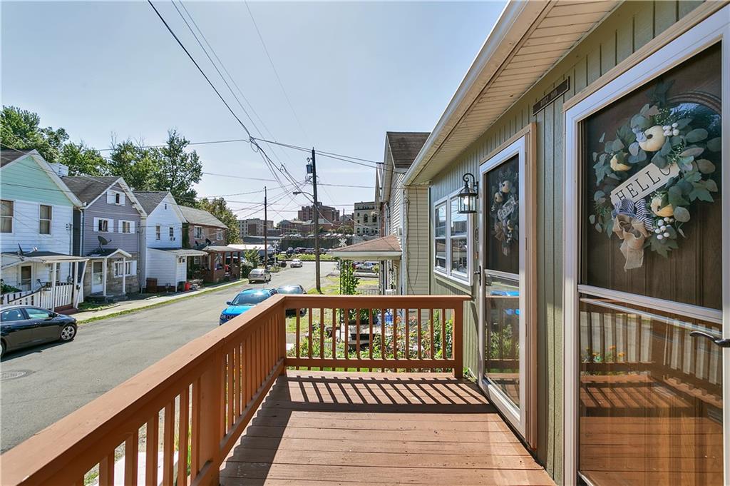 23-25 Locust Street Uniontown, PA 15401 - Photo 7 of 23 a view of a balcony with wooden floor and fence