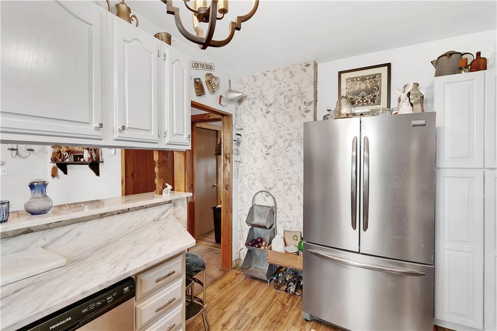 23-25 Locust Street Uniontown, PA 15401 - Photo 10 of 23 a kitchen with stainless steel appliances granite countertop a refrigerator a microwave and cabinets