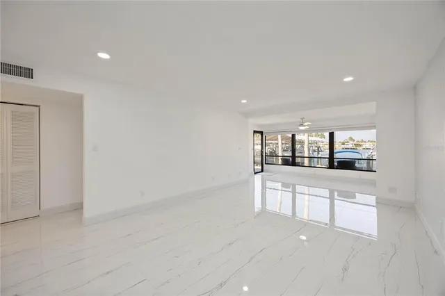 an empty room with closet and a ceiling fan