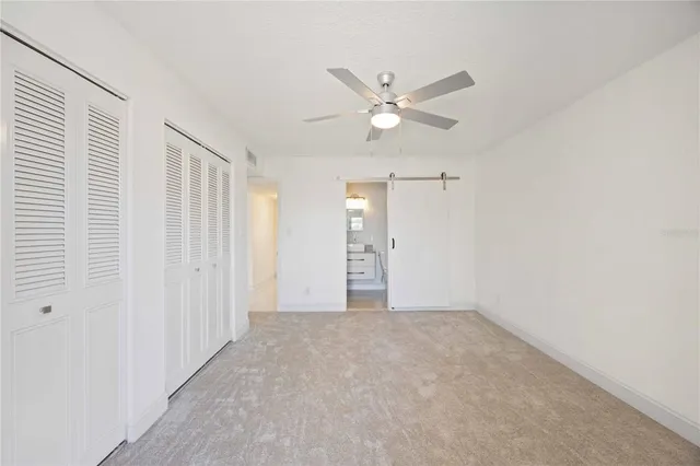 a bathroom with a granite countertop bathtub shower sink mirror and toilet