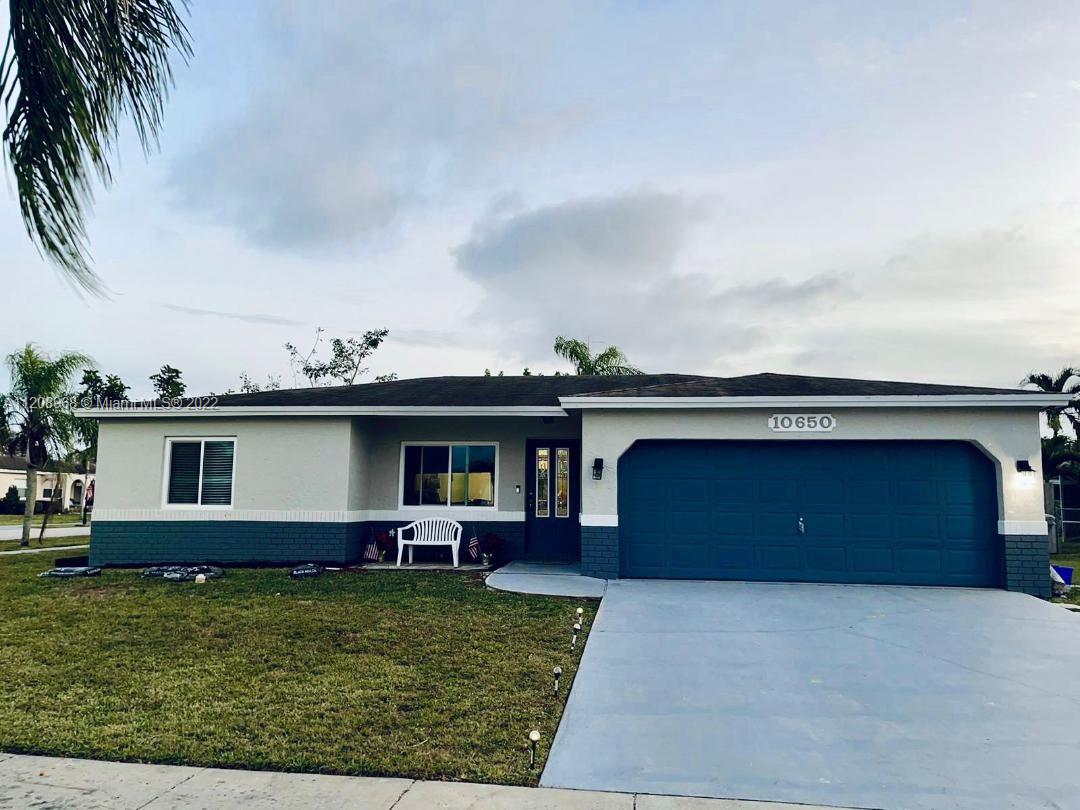 10650 Eland Street Boca Raton, FL 33428 - Photo 1 of 17 a front view of a house with garden