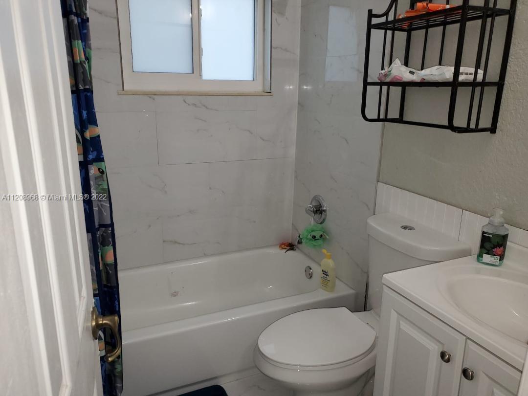 10650 Eland Street Boca Raton, FL 33428 - Photo 11 of 17 a bathroom with a toilet and a bathtub