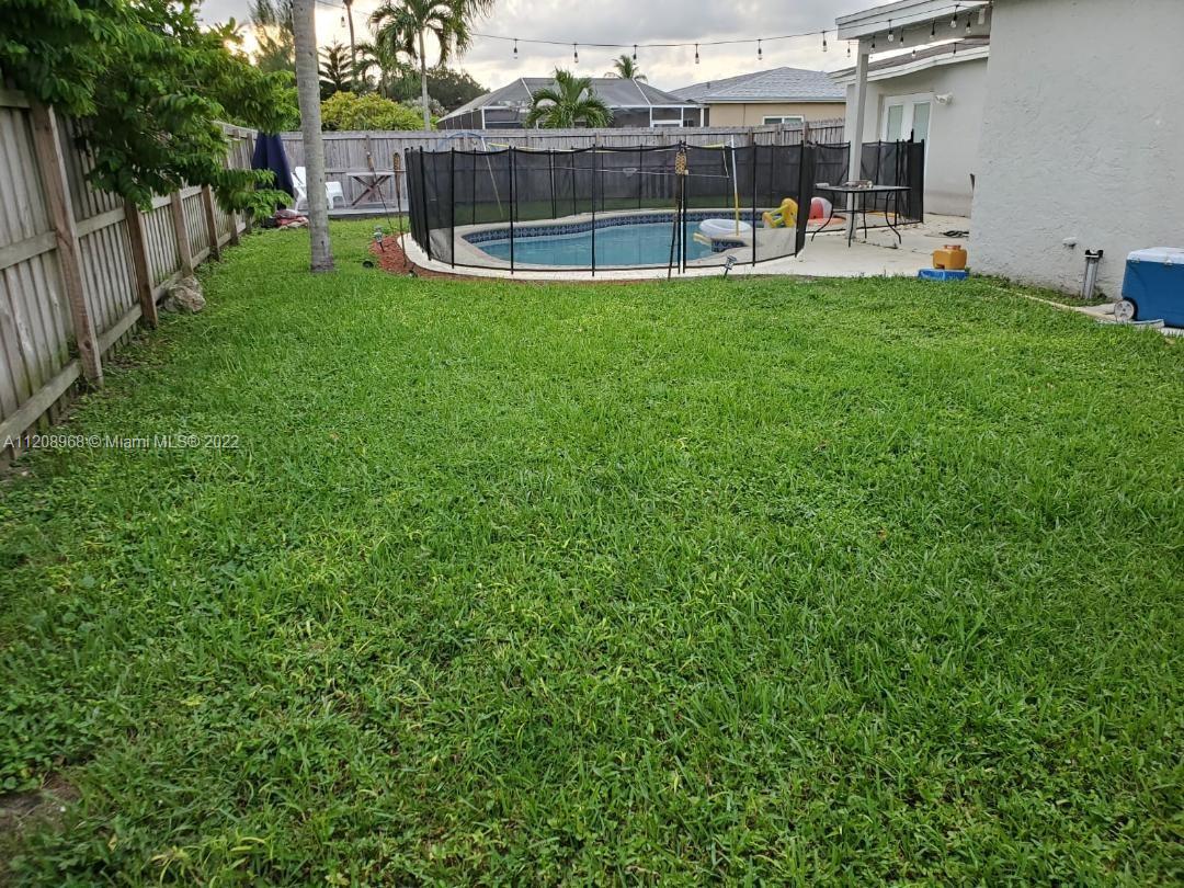 10650 Eland Street Boca Raton, FL 33428 - Photo 14 of 17 a view of a backyard with a patio and a slide