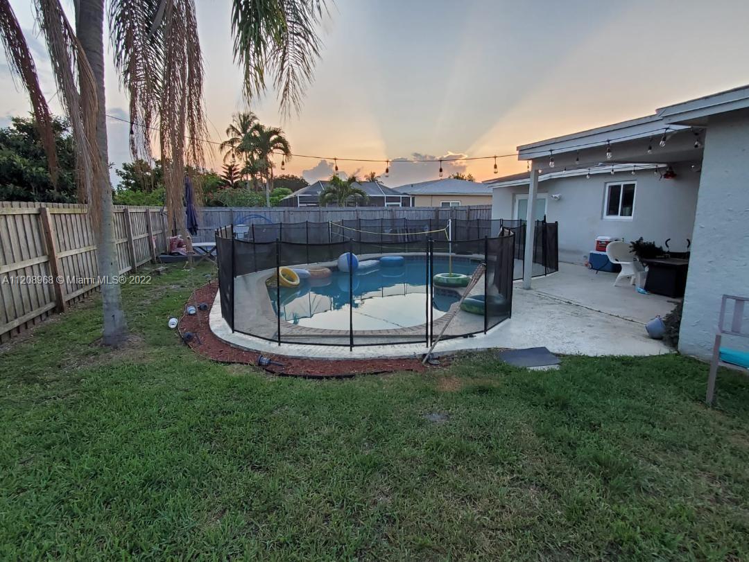 10650 Eland Street Boca Raton, FL 33428 - Photo 15 of 17 a view of a backyard with wooden fence