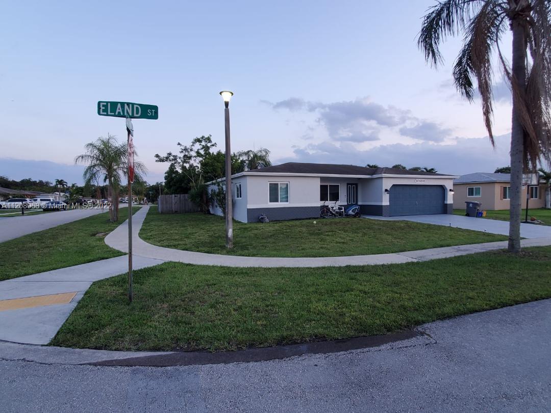 10650 Eland Street Boca Raton, FL 33428 - Photo 2 of 17 a view of a house with a yard and potted plants