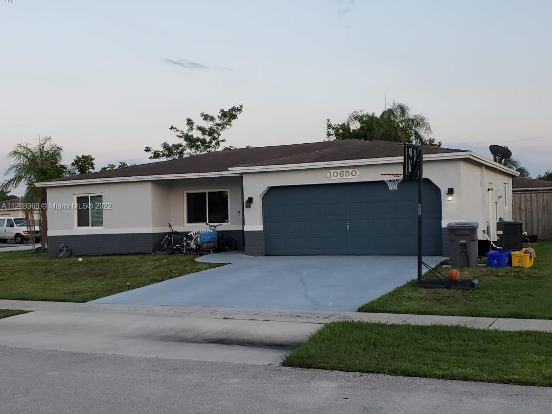 10650 Eland Street Boca Raton, FL 33428 - Photo 3 of 17 a front view of a house with a garden and garage