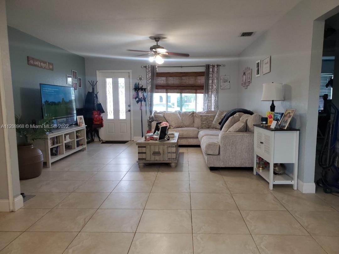 10650 Eland Street Boca Raton, FL 33428 - Photo 4 of 17 a living room with furniture and a flat screen tv