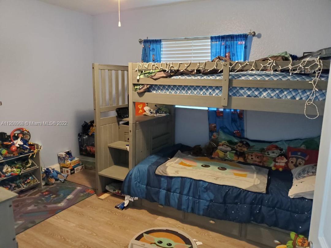 10650 Eland Street Boca Raton, FL 33428 - Photo 10 of 17 a room with furniture and a wooden floor