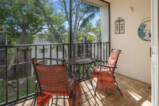 a view of balcony with wooden floor and outdoor seating