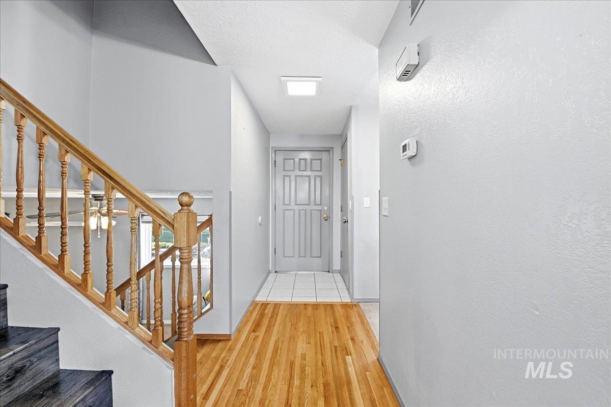 11842 Tioga Street Boise, ID 83709 - Photo 20 of 50 Entryway featuring wood-finish flooring transitioning to tile
