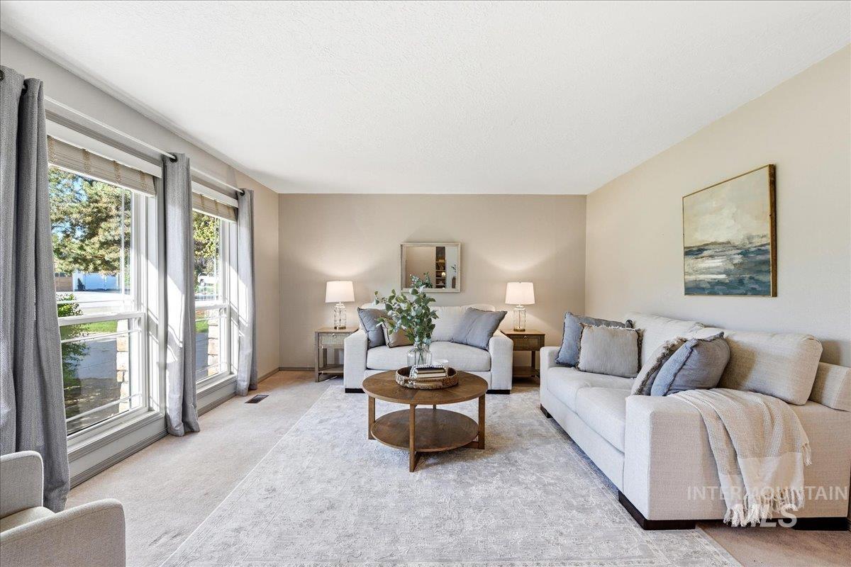 11842 Tioga Street Boise, ID 83709 - Photo 2 of 50 Living area featuring a textured ceiling, neutral wall paint, and light-colored carpeting throughout
