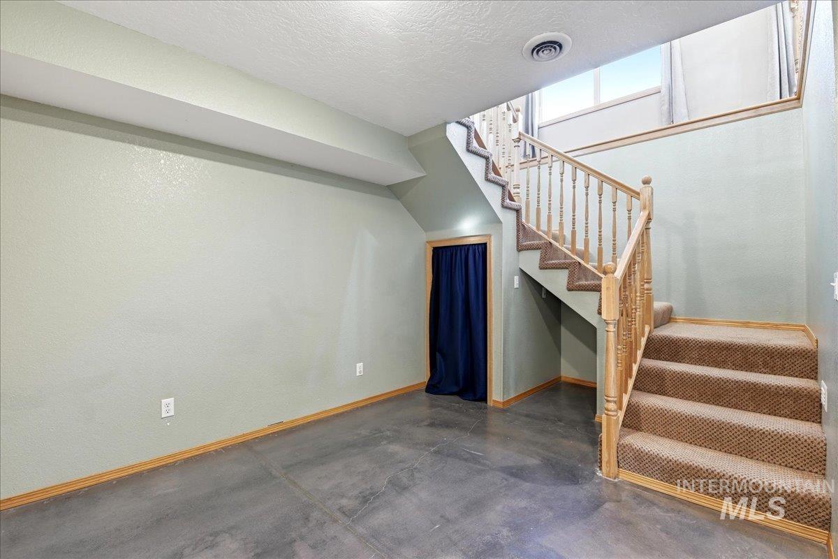 11842 Tioga Street Boise, ID 83709 - Photo 31 of 50 Carpeted staircase with natural wood balusters and handrail