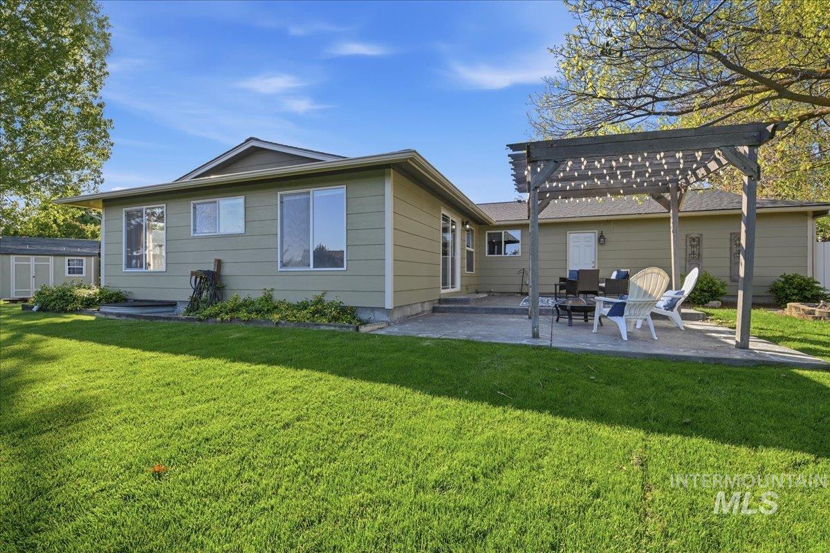 11842 Tioga Street Boise, ID 83709 - Photo 35 of 50 Expansive backyard featuring a large green lawn and a paved patio area