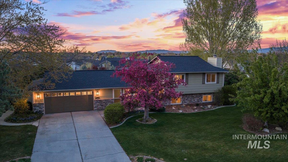 11842 Tioga Street Boise, ID 83709 - Photo 40 of 50 Split-level residence featuring a two-car garage, stone facade accents, and a dark shingle roof