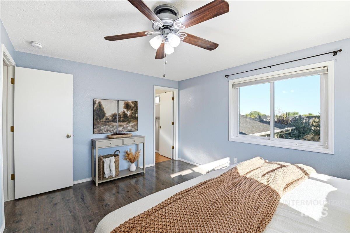 11842 Tioga Street Boise, ID 83709 - Photo 7 of 50 Spacious room featuring wood-finish flooring, a ceiling fan with integrated lighting, and light blue wall tones