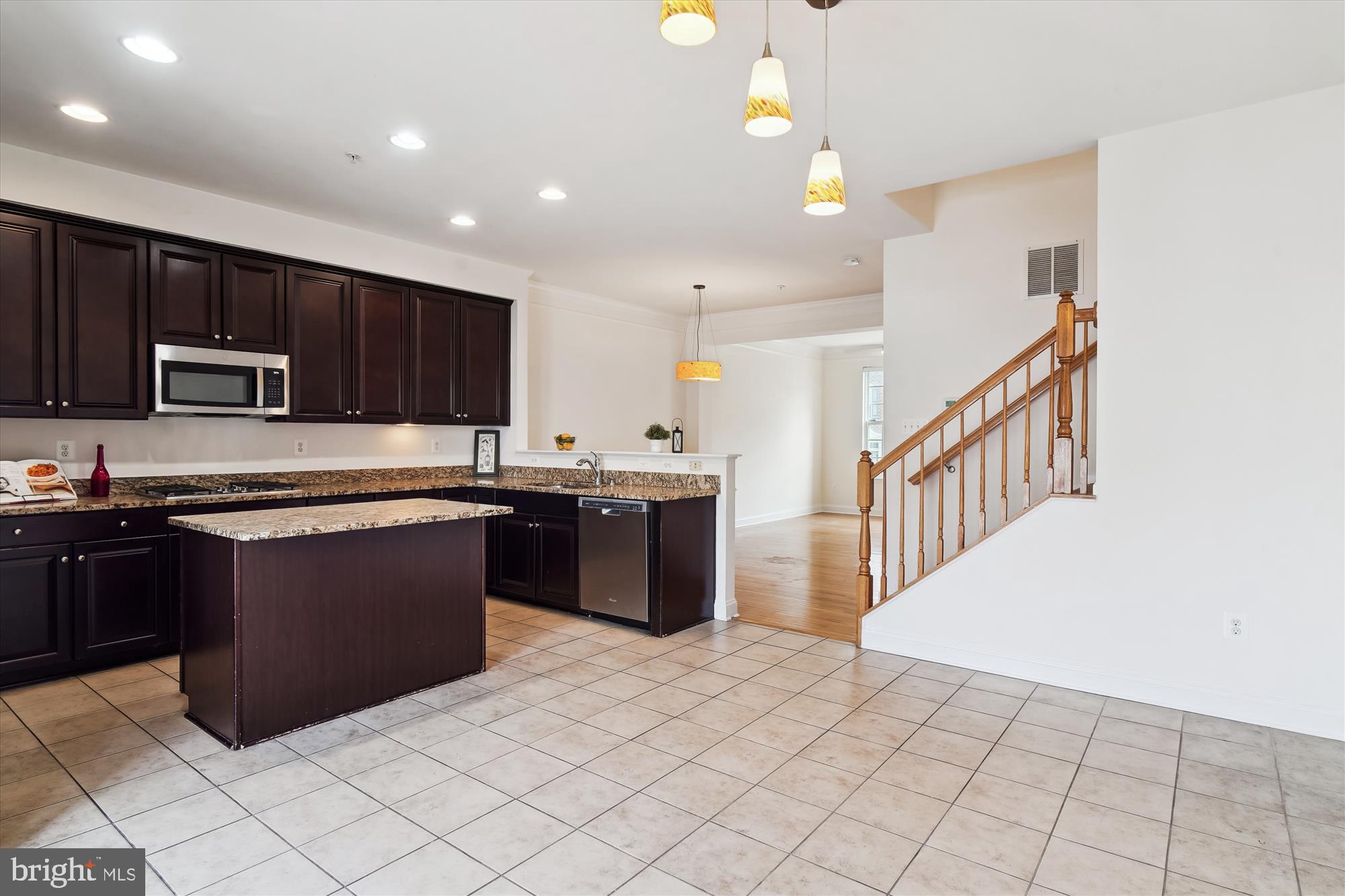 2607 Egret Way Frederick, MD 21701 - Photo 13 of 42 a kitchen with stainless steel appliances granite countertop a stove top oven a sink a counter top space and cabinets