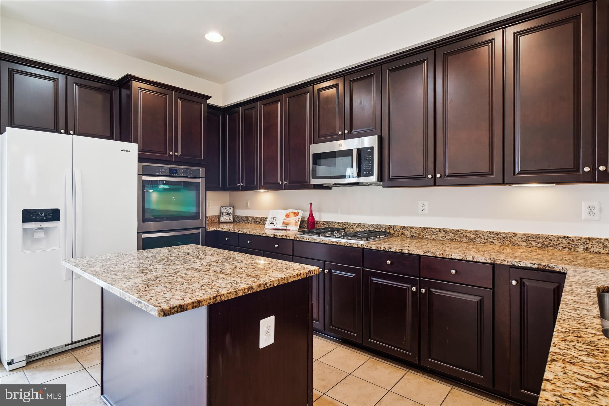2607 Egret Way Frederick, MD 21701 - Photo 6 of 42 a kitchen with granite countertop wooden cabinets and a stainless steel appliances