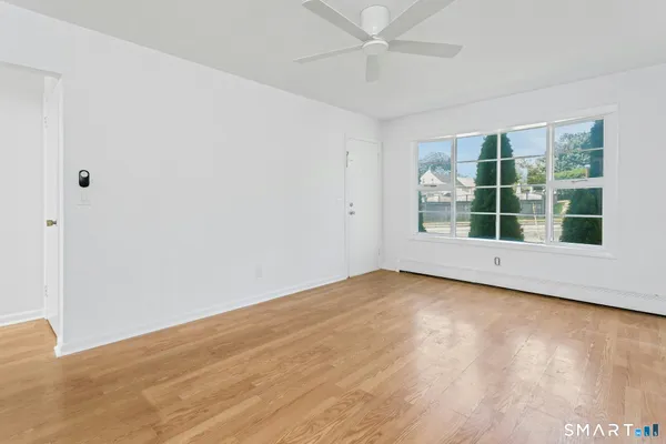 wooden floor in an empty room with a window