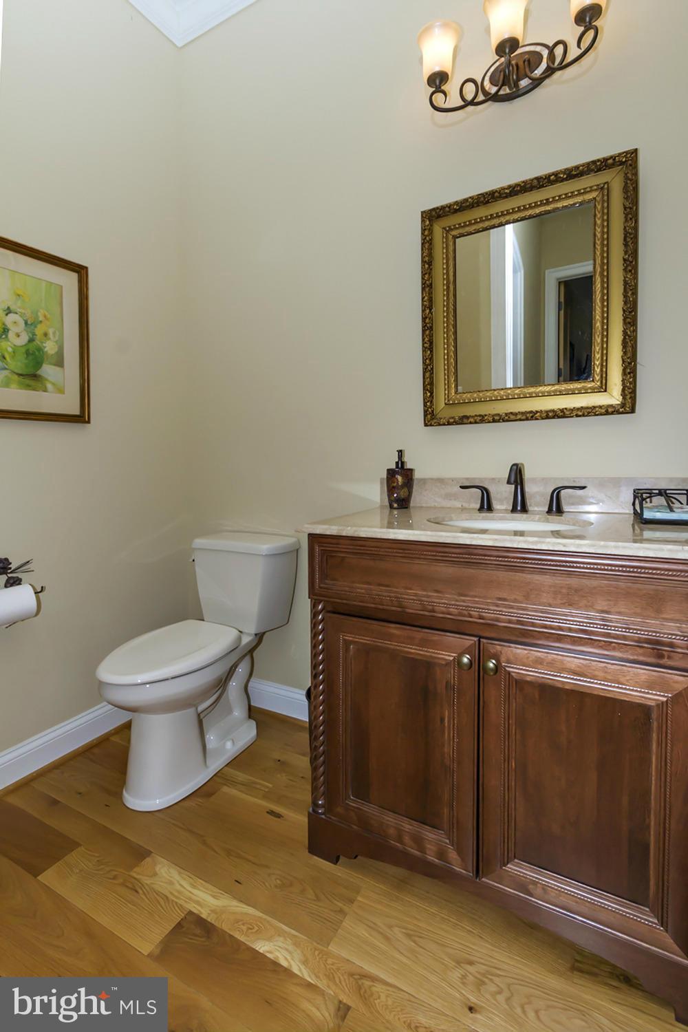 13001 Wainwright Road Highland, MD 20777 - Photo 12 of 30 a bathroom with a toilet sink and mirror