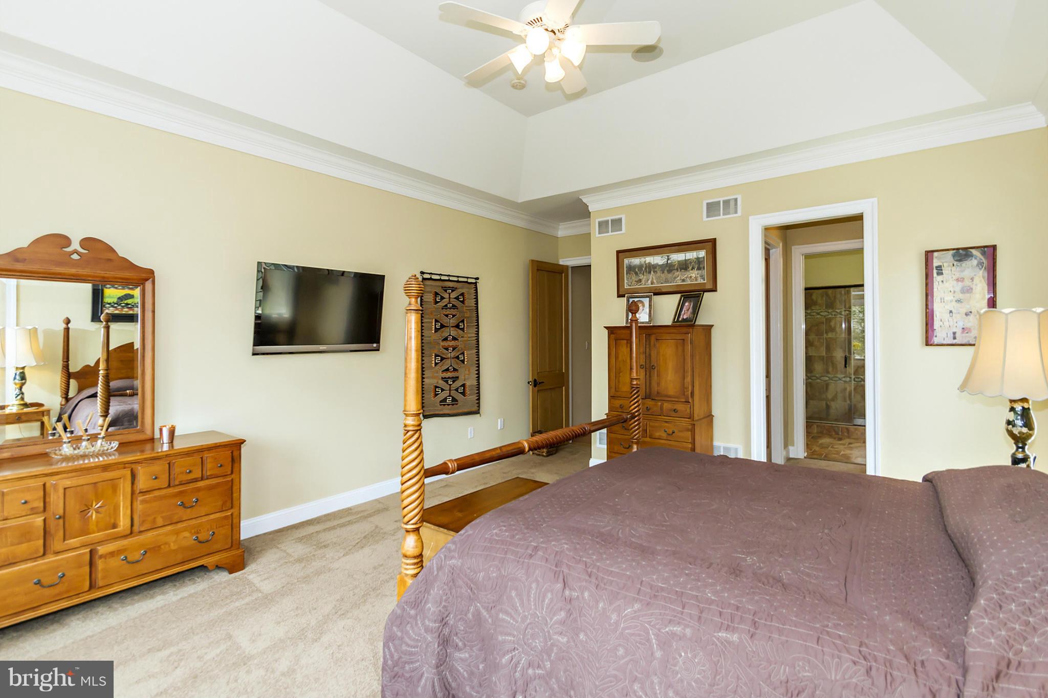 13001 Wainwright Road Highland, MD 20777 - Photo 14 of 30 a bedroom with a bed and a flat tv screen on dresser
