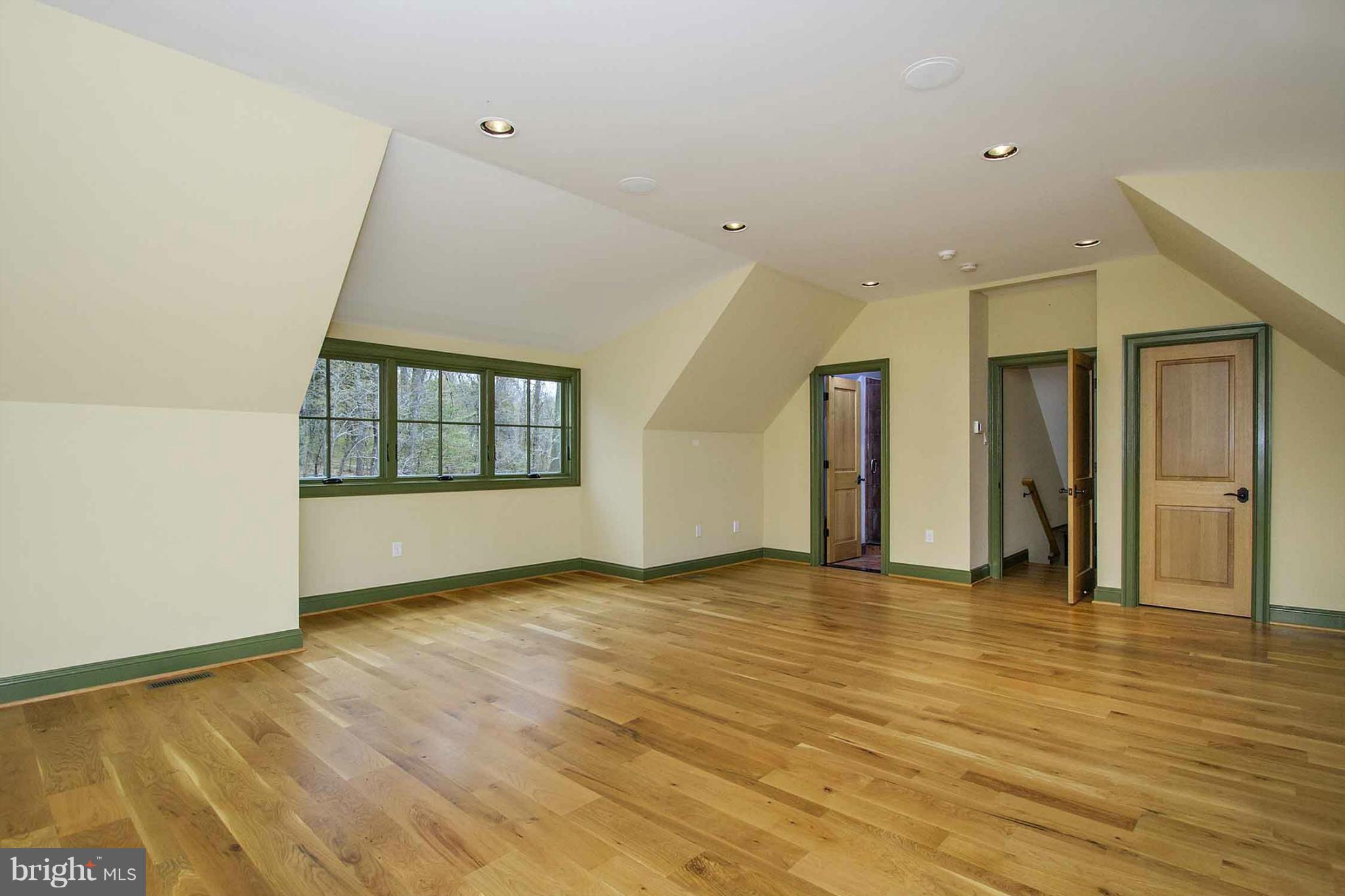 13001 Wainwright Road Highland, MD 20777 - Photo 18 of 30 a view of an empty room with wooden floor and a window