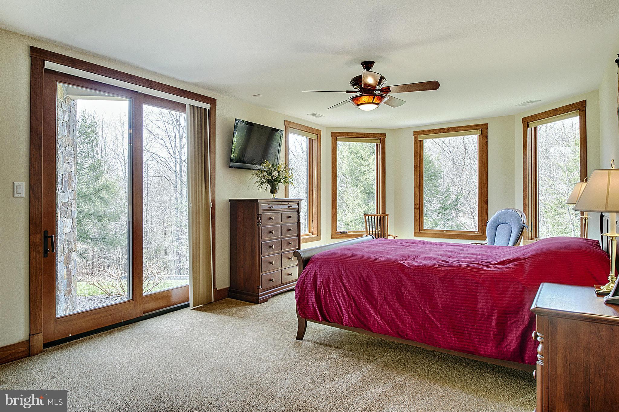 13001 Wainwright Road Highland, MD 20777 - Photo 22 of 30 a bedroom with a bed and a chandelier