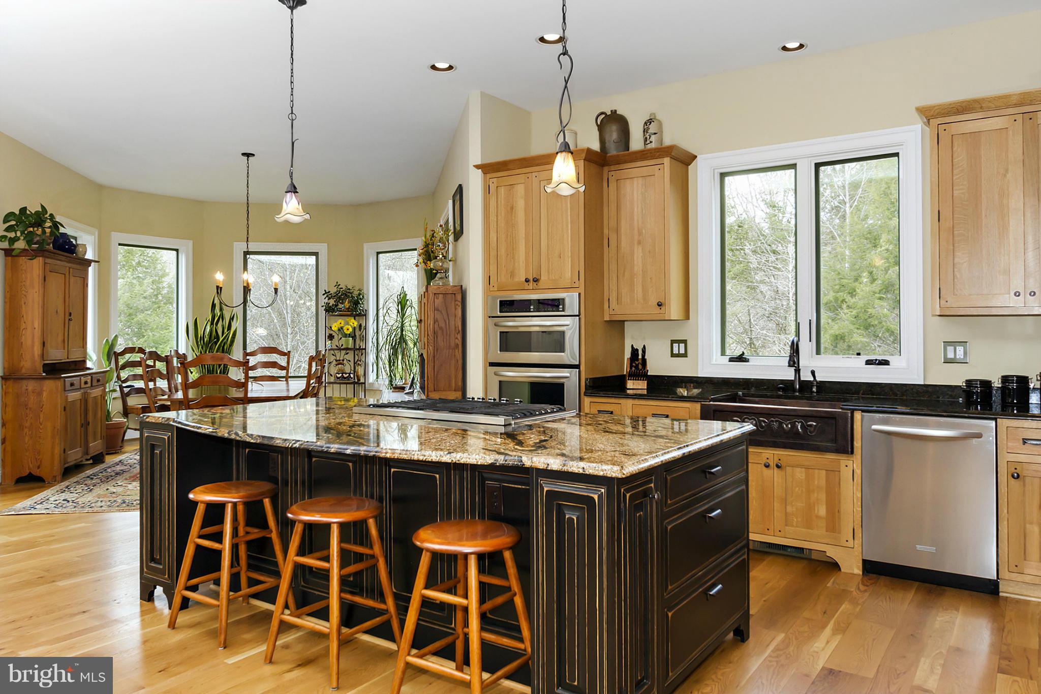 13001 Wainwright Road Highland, MD 20777 - Photo 9 of 30 a kitchen with a stove a sink a center island and windows