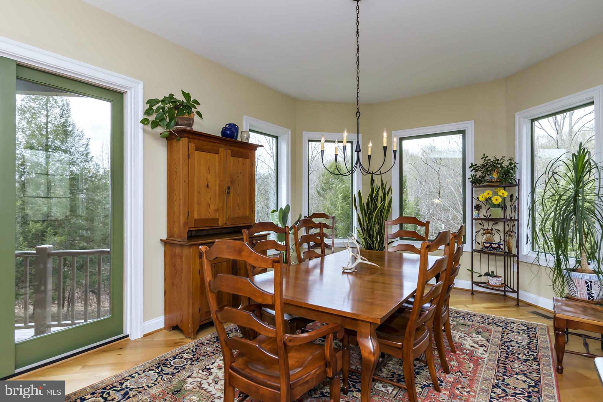 13001 Wainwright Road Highland, MD 20777 - Photo 10 of 30 a dining room with furniture a chandelier and wooden floor
