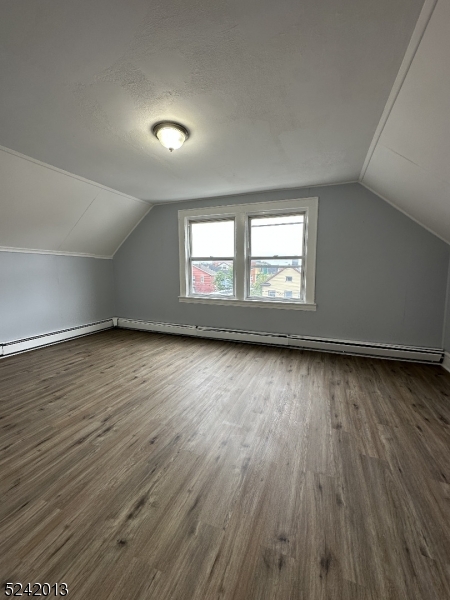 1032 Olive Street, Unit 3 Elizabeth, NJ 07201 - Photo 2 of 9 an empty room with wooden floor and windows