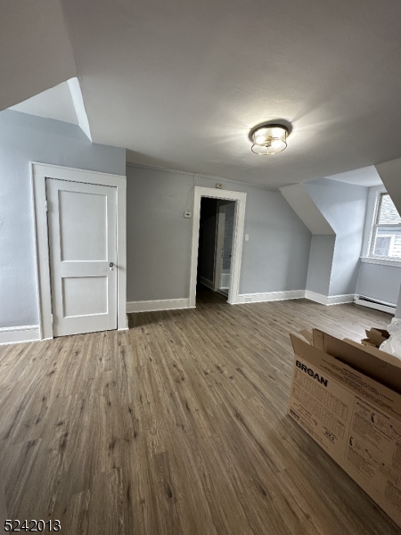 1032 Olive Street, Unit 3 Elizabeth, NJ 07201 - Photo 4 of 9 a view of an empty room and wooden floor