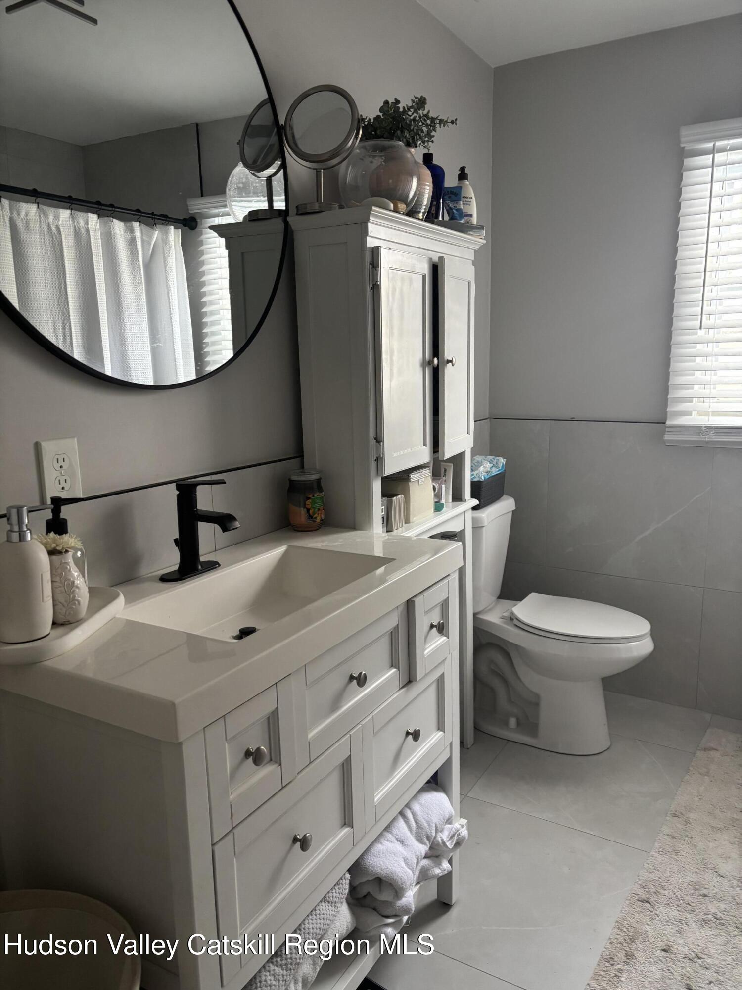 83 Marple Rd Extension Poughkeepsie, NY 12603 - Photo 11 of 23 a bathroom with a toilet sink and mirror