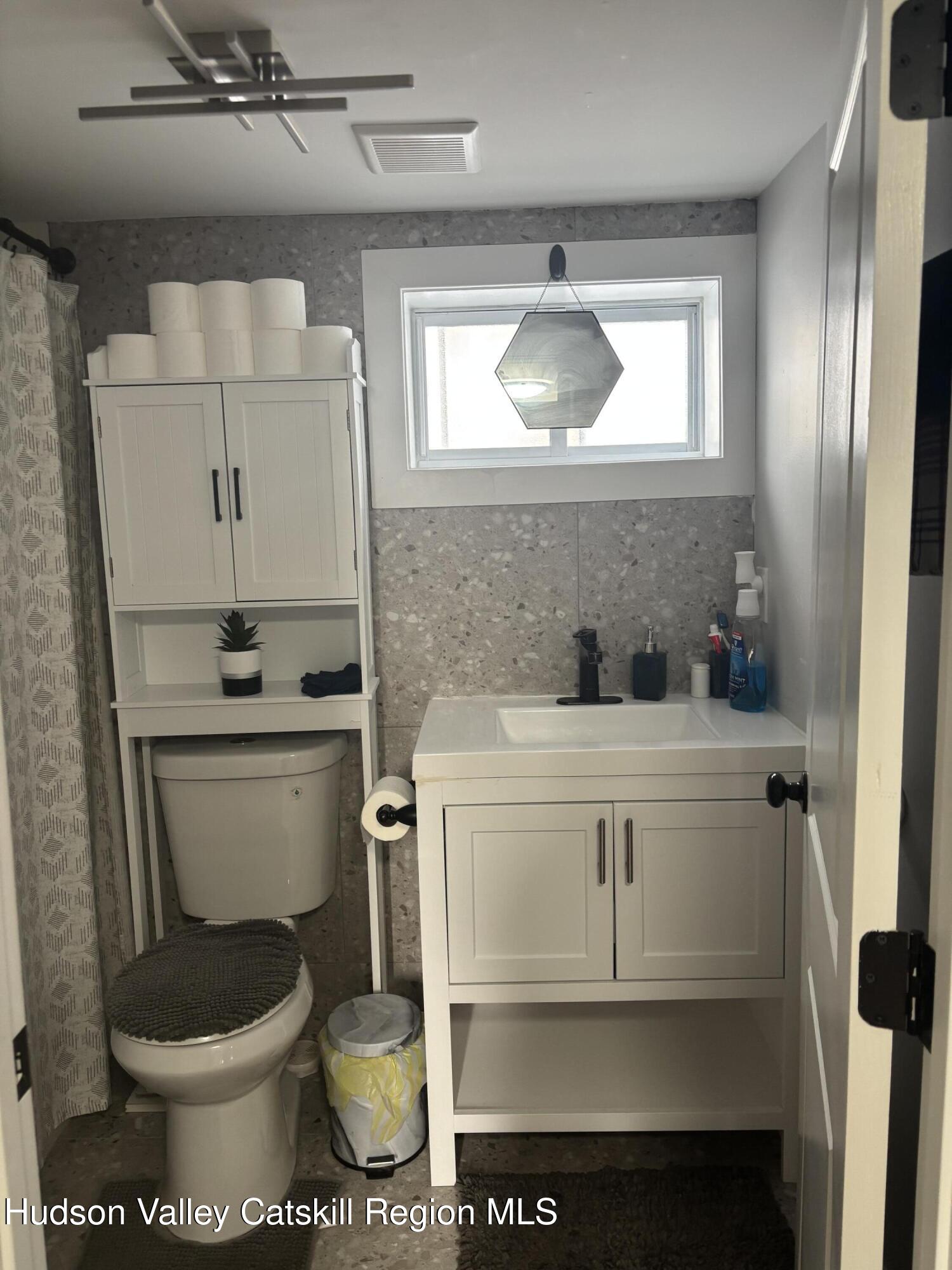 83 Marple Rd Extension Poughkeepsie, NY 12603 - Photo 14 of 23 a bathroom with a toilet sink and mirror