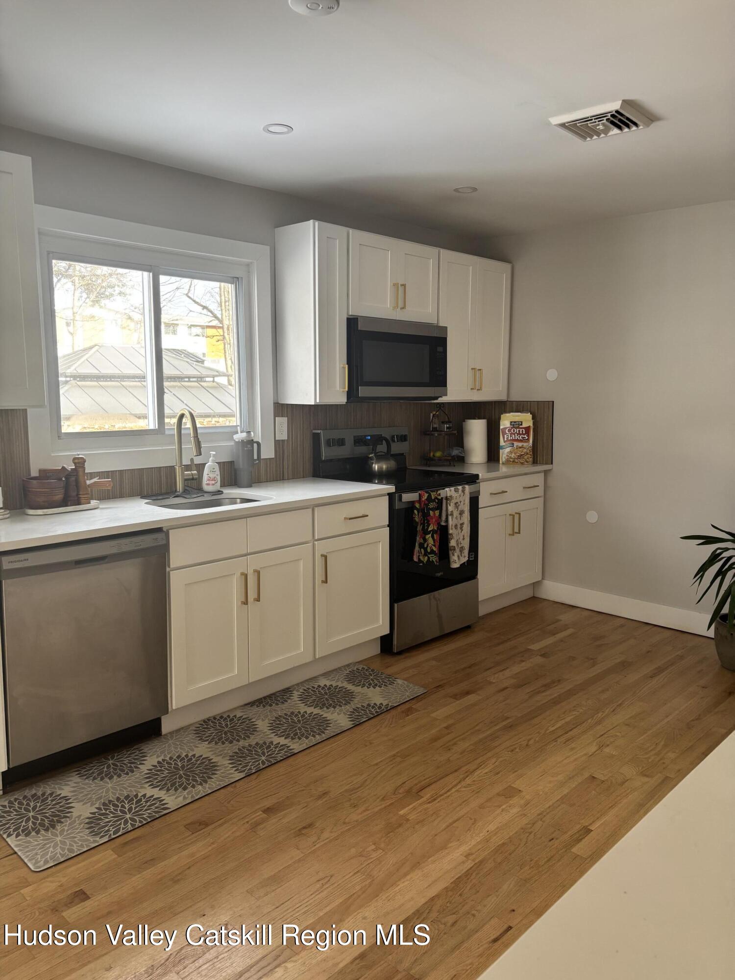 83 Marple Rd Extension Poughkeepsie, NY 12603 - Photo 2 of 23 a kitchen with stainless steel appliances granite countertop a sink a stove top oven a counter space and cabinets