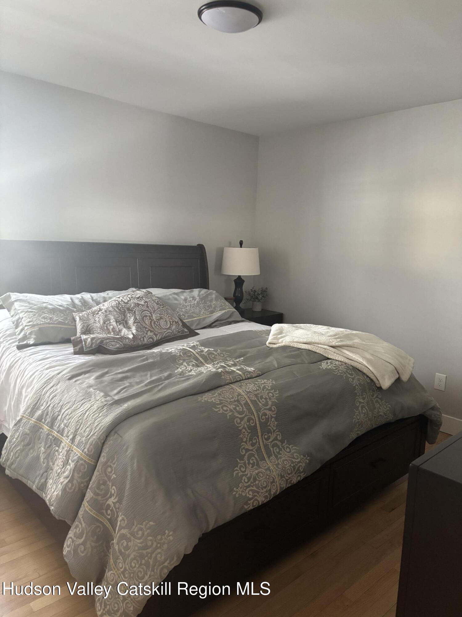 83 Marple Rd Extension Poughkeepsie, NY 12603 - Photo 8 of 23 a bedroom with a bed and a night stand