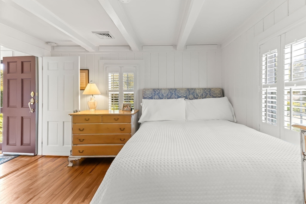 751 Crowell Road Chatham, MA 02650 - Photo 11 of 41 a bedroom with a bed and windows
