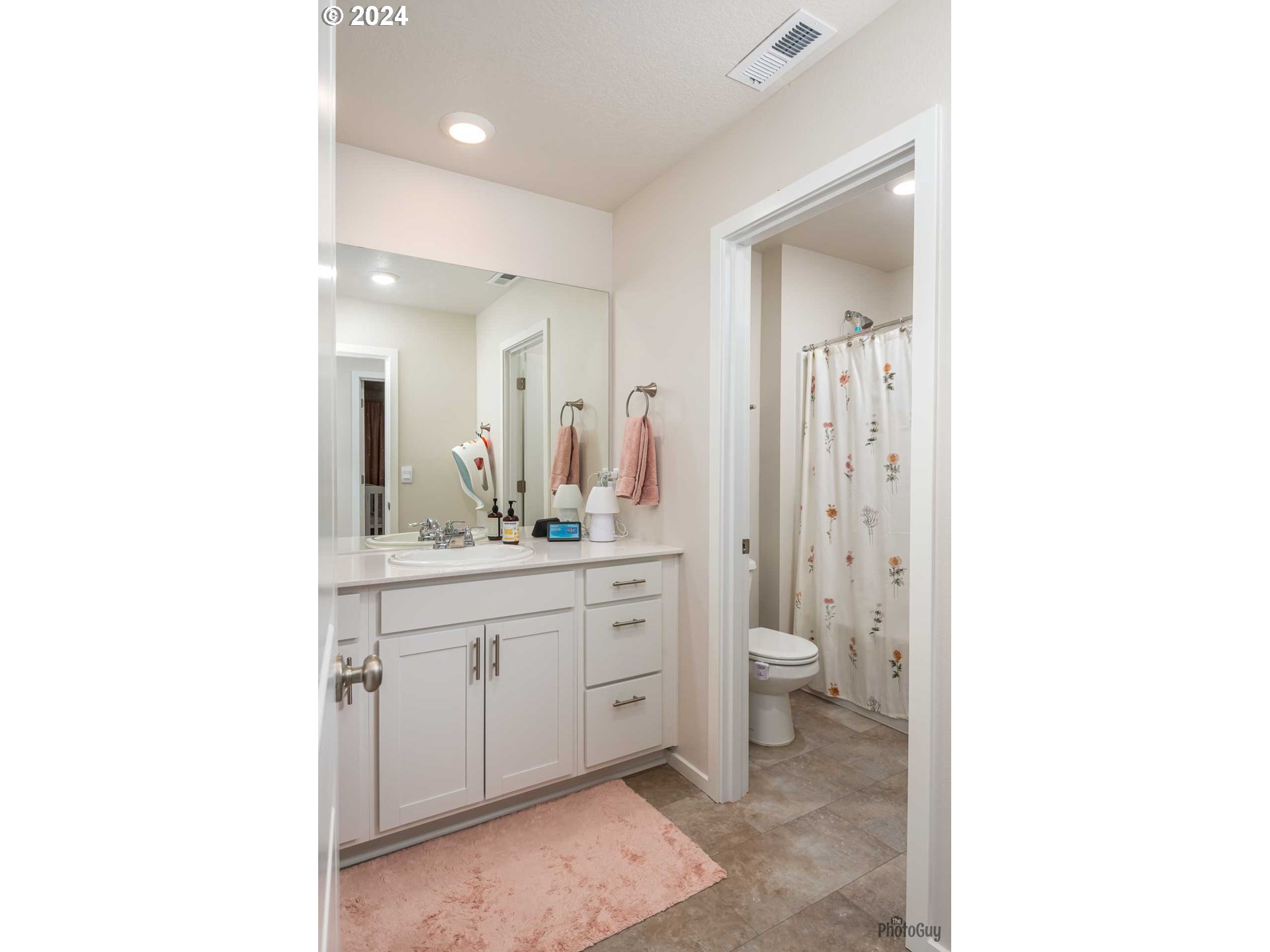 2661 26th Loop Springfield, OR 97477 - Photo 29 of 43 a spacious bathroom with a double vanity sink a toilet and a mirror